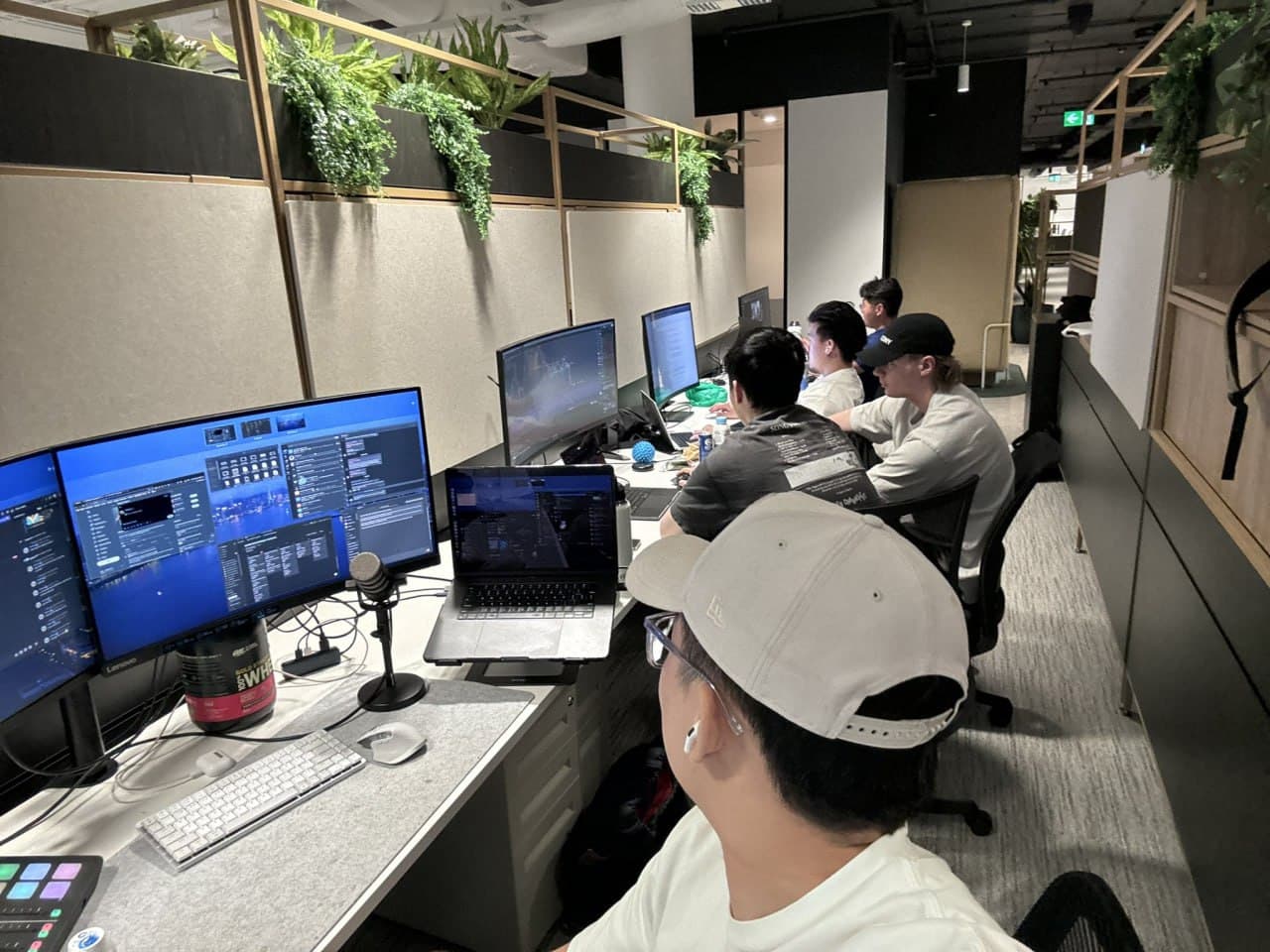 Surgence Labs operators working from a shared production desk